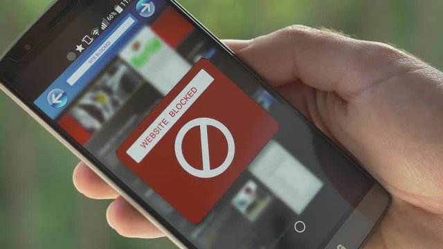 Smartphone screen with a message informing that the website is blocked. Many reasons : governments blocking, parental control, Internet provider control, Boss control etc..