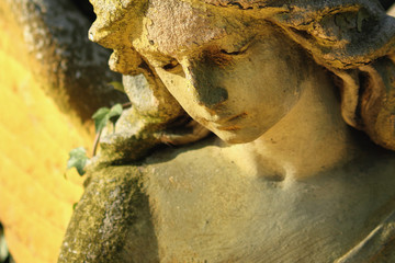 Fototapeta premium Majestic view of statue of golden angel illuminated by sunlight