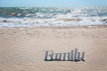 Word family on a sand, close up