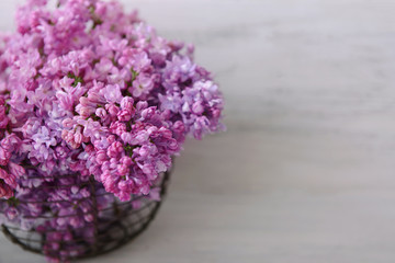 Bouquet of spring flowers on white wooden background