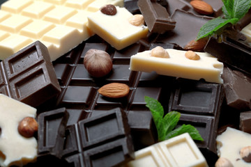 Chocolate pieces with mint leaves, background