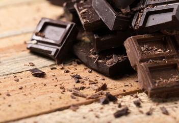 Chocolate pieces on wooden background