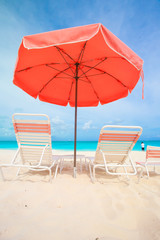 Sunbeds and umbrellas at beautiful tropical resort