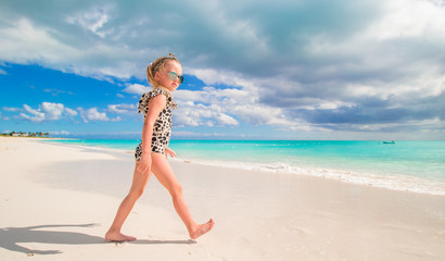 Adorable little girl at shallow water on the beach