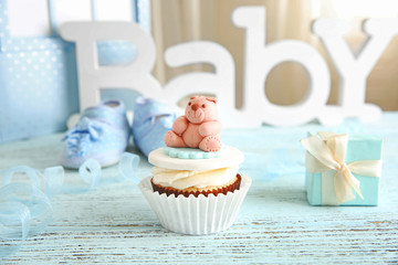 Letters of word baby and cupcake on the table