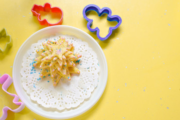 image of hand made cake or cookies on white plate with molds around