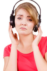 Fototapeta premium Woman sad girl in big headphones listening music