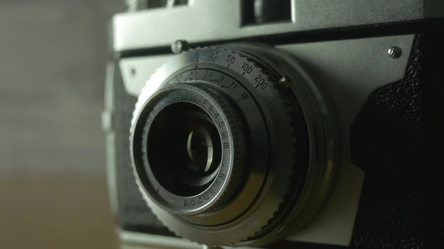 Retro old vintage 35mm film camera . Camera panning and turning around it.