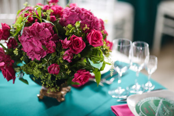 flower arrangement in bowl with pink roses and hydrangea. table setting