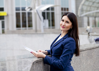 Fototapeta premium Young beautiful woman in a blue jacket