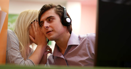 smiling office workers in a call center with phones