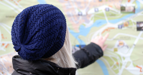 Woman standing in front of tourist city map