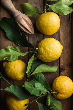Fresh lemons with leaves in rustic wooden box
