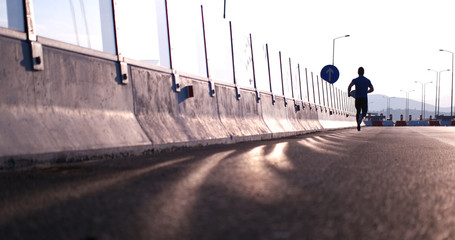 Running at sunrise man exercising for marathon and workout fitne