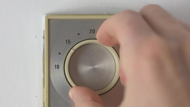 Turning down the temperature of the home heater thermostat. Turning the thermostat up or down several degrees will heat or cool your building faster. Energy saving.