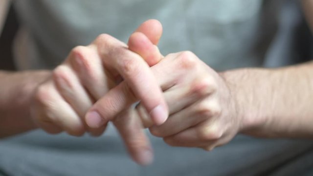 Hands of a caucasian adult man being anxious, nervous and uncomfortable.