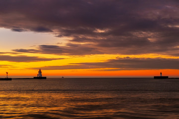 Naklejka na ściany i meble Lake Erie beacons at the mouth of Cleveland's harbor at sunset