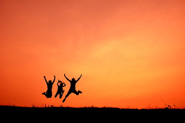 Silhouette women and children open hand in the sunset