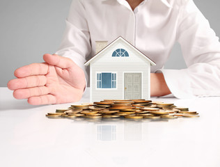 Mortgage concept by house from  hand