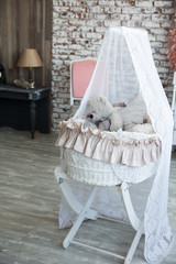 Children wicker cradle with teddy bears