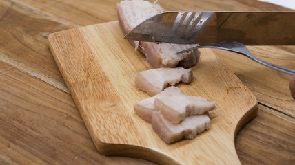 Fototapeta na wymiar pork on wooden block with knife