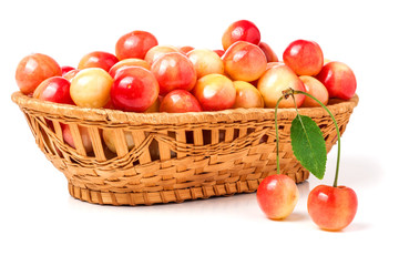 Fototapeta na wymiar yellow cherries in a wicker basket isolated on white background