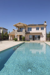 Luxury Pool in front of private mansion with solar panels.
