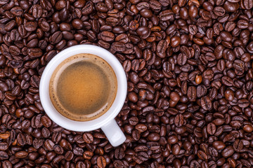 Cup on coffee beans