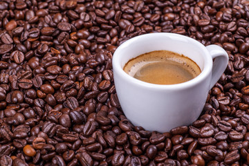 Cup on coffee beans