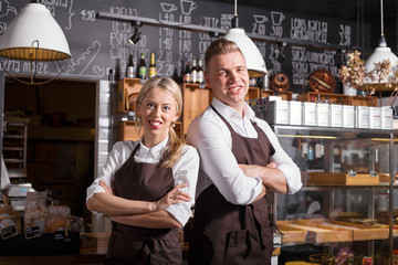 Coffee shop owners standing with their hands crossed
