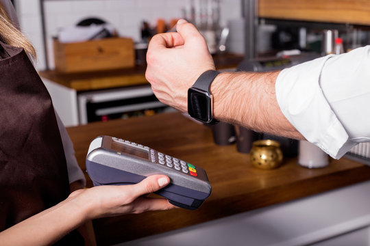 Person scanning smartwatch for payment