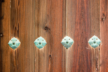 Wooden wall with decorative  broze rivets