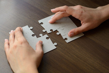 Folding puzzle hand parts on a wooden table