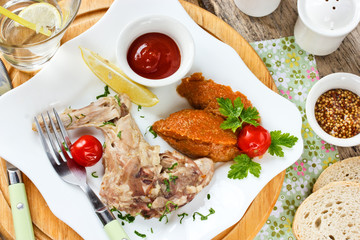 Rabbit leg boiled with herbs, vegetable puree and tomato sauce