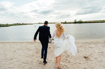 Bride and groom walking at the river