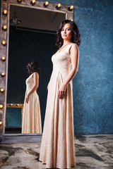 Obraz premium portrait of beautiful elegant young woman in gorgeous evening dress