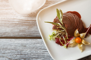 Cooked pear on white plate. Fruit with sauce and herb. Wine sauce and sweet pear. Natural food with decoration.