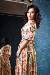 portrait of beautiful elegant young woman in gorgeous summer dress