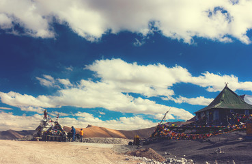 Young happy friends cyclists standing on road in Himalayas mountains , North India