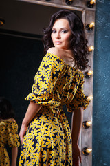 portrait of beautiful elegant young woman in gorgeous summer dress
