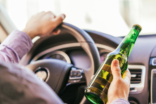 Man Drinking Alcohol While Driving The Car