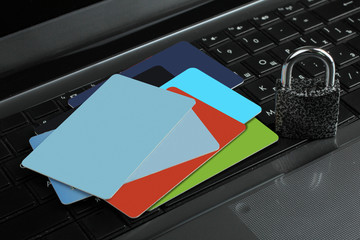 credit card on laptop keyboard near the padlock close-up