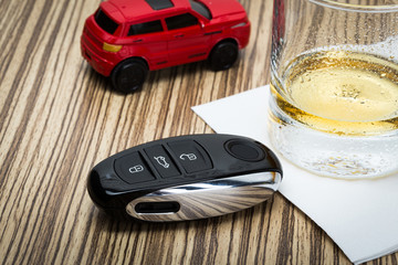 toy car and glass of whiskey metaphor crash accident isolated on white