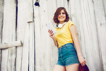 Fototapeta premium Funny Hipster Girl over white old wooden wall, hipster outfit Going Crazy at tropical island.Trendy Casual Fashion Outfit in summer,spring.Toned Photo,Copy Space.