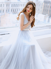 Bride in a tender light blue wedding dress in a morning. Fashion beauty portrait