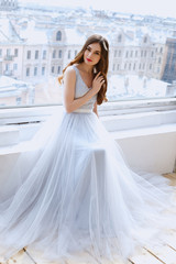 Bride in a tender light blue wedding dress in a morning. Fashion beauty portrait
