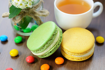 Tea and macaroons on a wooden table
