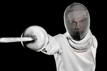 Man wearing fencing suit practicing with sword