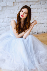 Naklejka premium Bride in a tender light blue wedding dress in a morning. Fashion beauty portrait