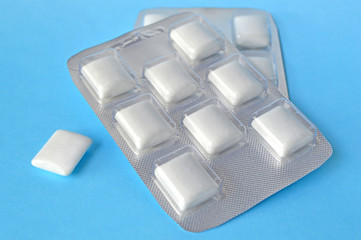 White chewing gum on blue background